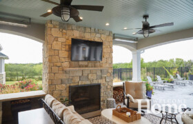 The fireplace on the patio, along with an outdoor television, entice people to enjoy the outdoors.