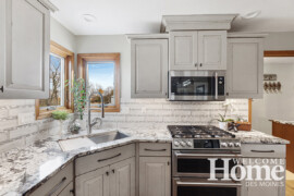 Recently replaced windows and trim served as the starting point for wood selections for the floor and island, as well as new cabinetry in the adjoining laundry room.