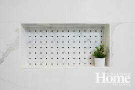 The homeowners chose genuine marble tile in a basket weave pattern for the floor and wall niche in the glass-enclosed shower.