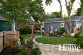 The compact backyard showcases a pergola made by a friend and a fire pit with the requisite Adirondack chairs, just right for a teenage son's friends to gather.