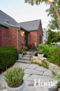 Stonework took a curved approach, too, with gentle curves in the sidewalk near the driveway.