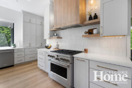 The range hood and floating shelves are close at hand.