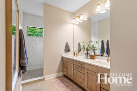 The high-placed window allow light and privacy in the primary bathroom.