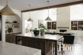 Tall ceilings add to the sense of open spaces in this Caliber Homes kitchen and family room.