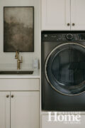The laundry area is located near the primary closet and the mudroom.