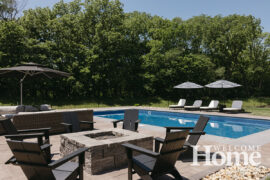 A stone firepit surrounded by Adirondack chairs is a pleasant spot to gather on a cool evening.