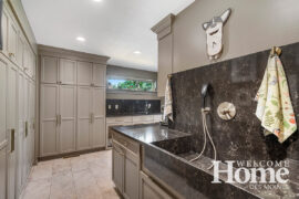 A deep sink and pull-down faucet serve as a coveted dog-washing station for the family's Corgis.