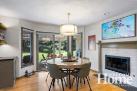 The existing table and chairs fit perfectly in the redesigned kitchen, next to the freshly painted fireplace.
