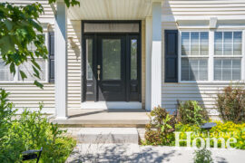 These homeowners created a statement entry with a new door that features a ¾ light, sidelights, and a transom window.