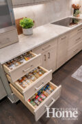 Woodharbor's custom cabinetry features built-ins for every purpose, including multiple spice drawers.